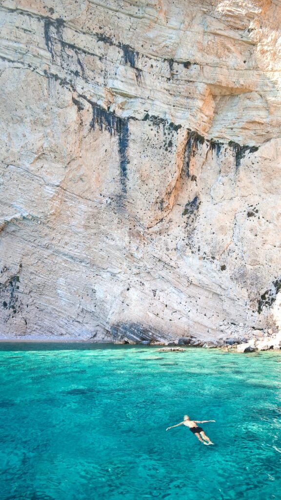 4 Important skills to learn for Solo Traveller Person Learning Swimming Skill Near Brown Cliff