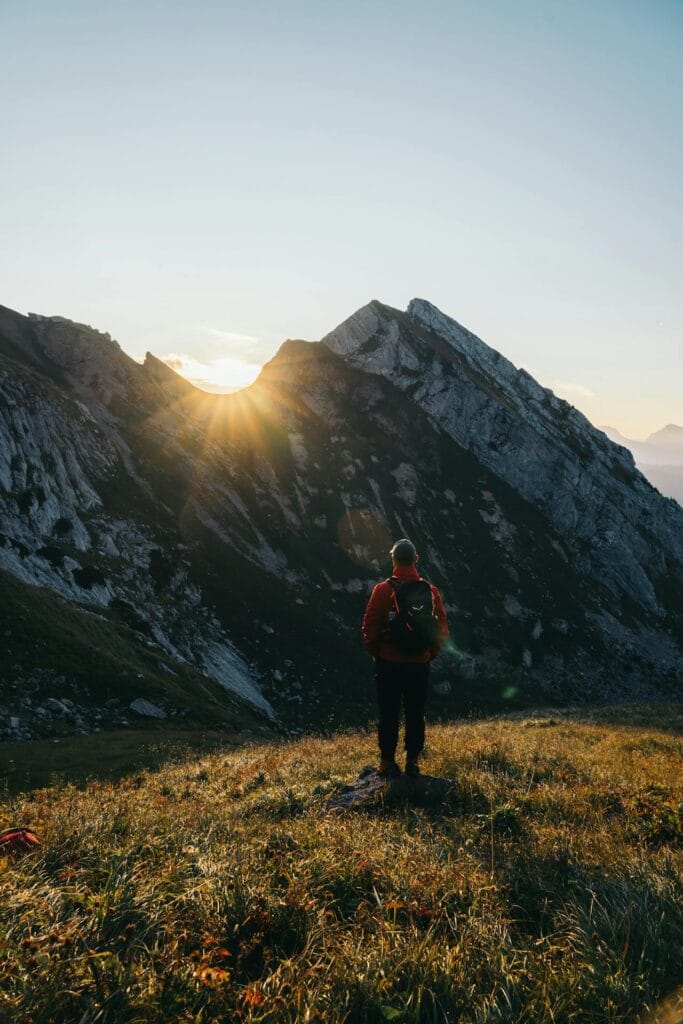 What is solo traveling? solo traveler watching mountain sunrise