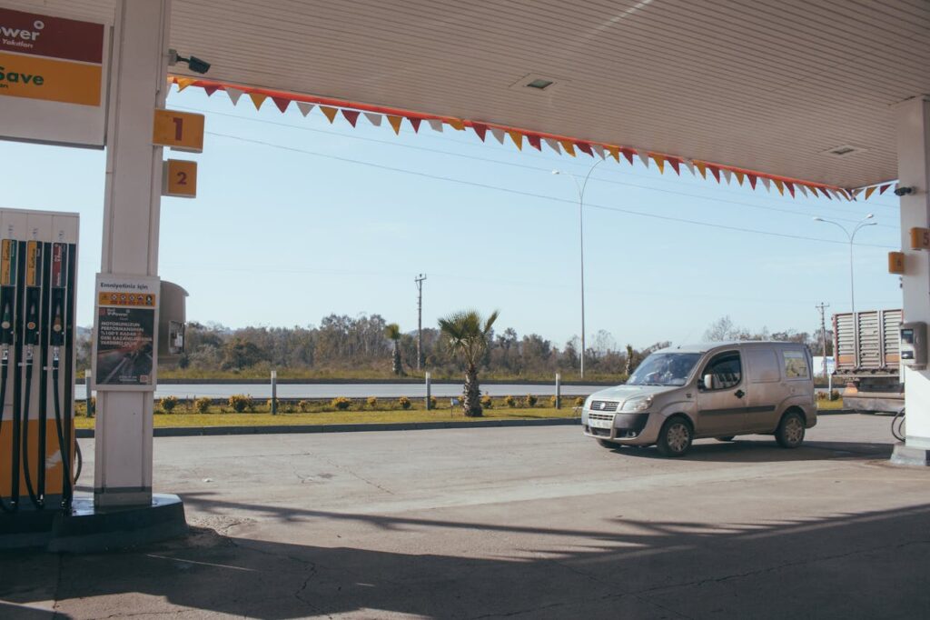 13 Best Tips For Hitchhiking (Beginners) A Car near gas station against cloudless sky
