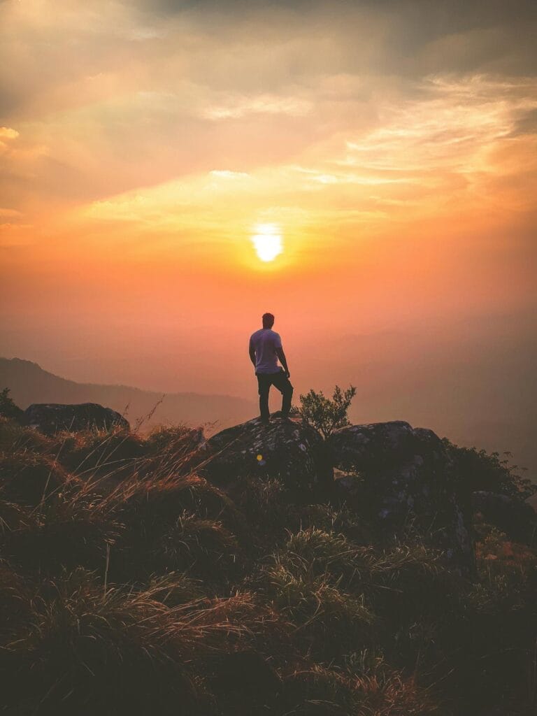 What is solo traveling? a traveler Standing on Rock During Sunset